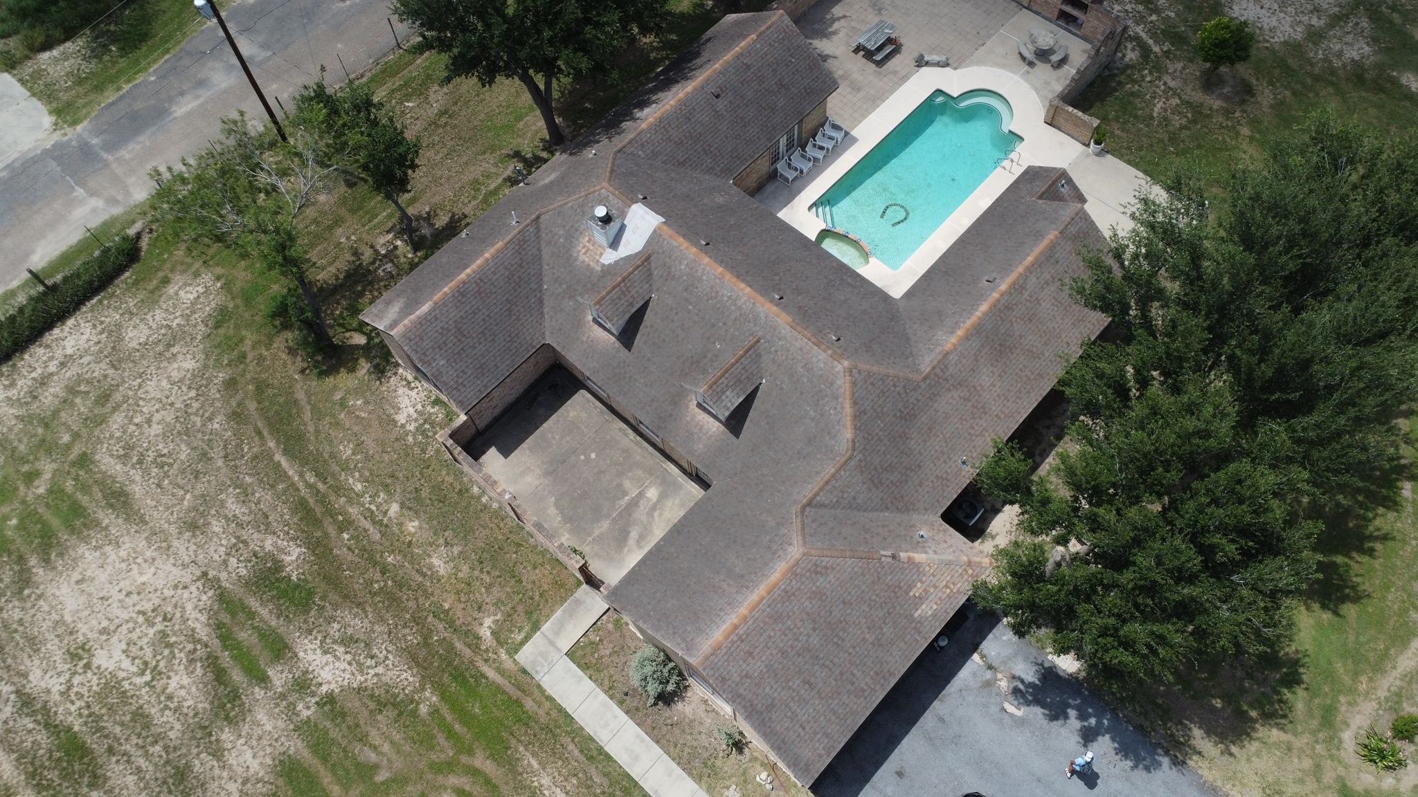 Completed shingle roof replacement seen from above on a Rio Grande Valley home