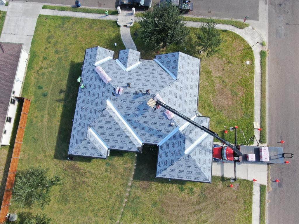 Hidalgo Roofing crew tearing off an old roof on a Rio Grande Valley home