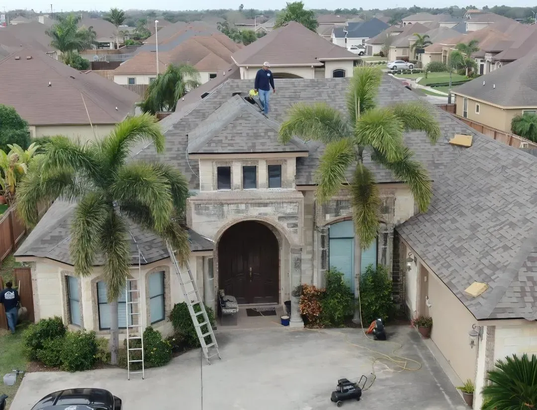 Hidalgo Roofing crew installing a new shingle roof on a home in Pharr, Texas