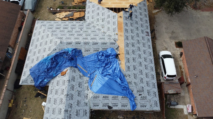 Emergency tarp secured over storm-damaged shingles on a home in McAllen, Texas