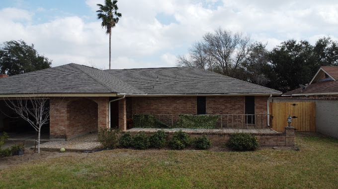Aging asphalt shingle roof on a Rio Grande Valley home before replacement